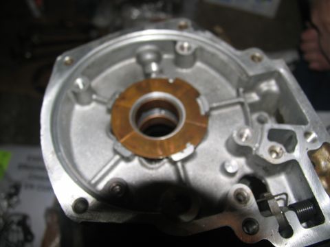 1978 Ford Bronco - A detailed view of a disassembled transmission part, showing internal components and a copper washer.