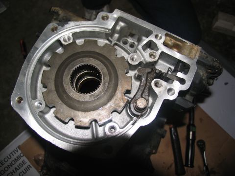 1978 Ford Bronco - Close-up view of a disassembled transmission component, showing internal gears and a linkage mechanism.