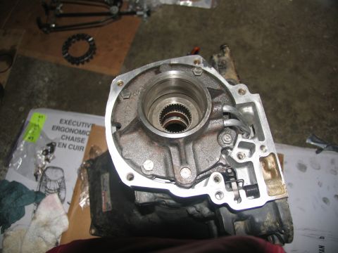1978 Ford Bronco - A disassembled transmission pump housing sits on a work surface, surrounded by tools and packaging.