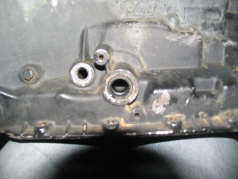 1978 Ford Bronco - Close-up view of a Ford transmission casing, showing various ports and the embossed Ford logo.