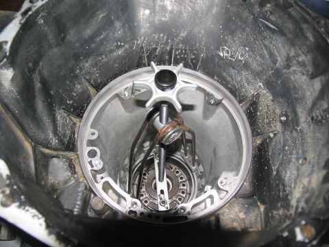 1978 Ford Bronco - Close-up view of the interior of a transmission bell housing, showing internal components and a specialized tool.