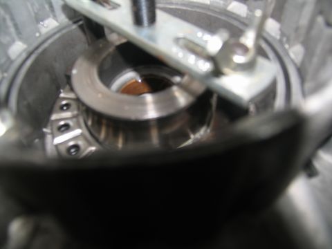 1978 Ford Bronco - Internal transmission component with a tool, likely during a rebuild process.