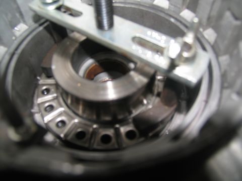 1978 Ford Bronco - A tool is used to work on a part inside a transmission housing.