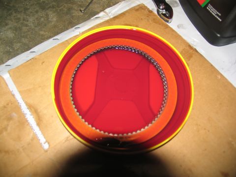 1978 Ford Bronco - A transmission clutch pack is submerged in red fluid, with metal rings visible.