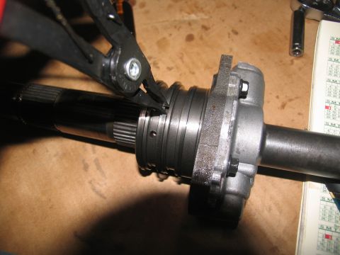 1978 Ford Bronco - Snap ring pliers are used to remove a snap ring from a transmission shaft.