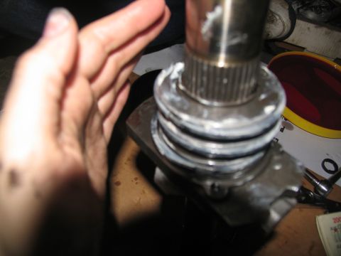 1978 Ford Bronco - Close-up of a transmission part being worked on, showing a splined shaft and grease application.