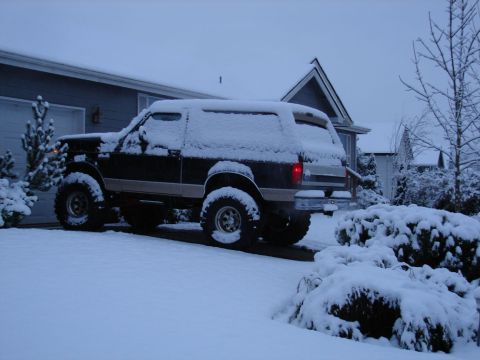 1996 Ford Bronco - Ford Bronco sits covered in snow during winter weather.