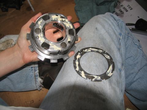 1978 Ford Bronco - Close-up of a transmission clutch component being held, with a related ring part visible.