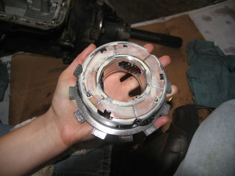 1978 Ford Bronco - A person holds a disassembled transmission clutch pack, showing its internal components.