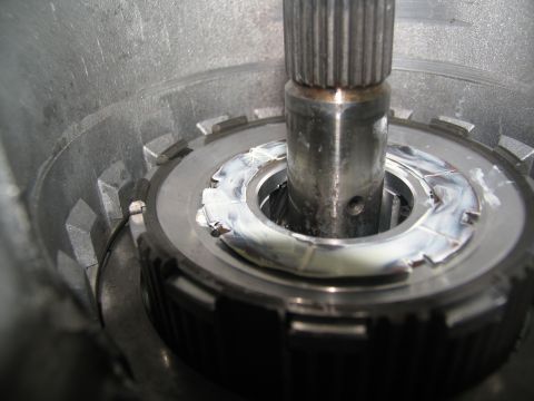 1978 Ford Bronco - A close-up view of a transmission part, showing a metal shaft and a greased ring with visible wear.