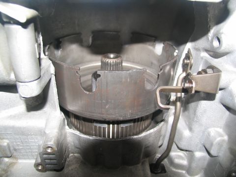 1978 Ford Bronco - A damaged transmission drum shows signs of wear and tear within the transmission housing.