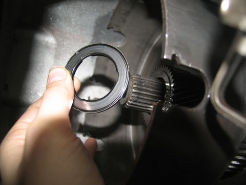 1978 Ford Bronco - A close-up view of a transmission component being held by a hand.