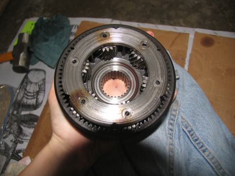 1978 Ford Bronco - A person holds a planetary gear set, likely for a transmission rebuild.