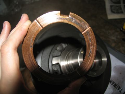 1978 Ford Bronco - A close-up view of a damaged bearing race, showing significant wear and scoring from use.