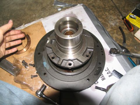 1978 Ford Bronco - Close-up of a transmission pump assembly with a bearing and bolts laid out on cardboard.
