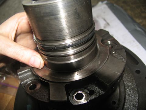1978 Ford Bronco - A close-up view of a worn transmission part being inspected, likely during a rebuild process.