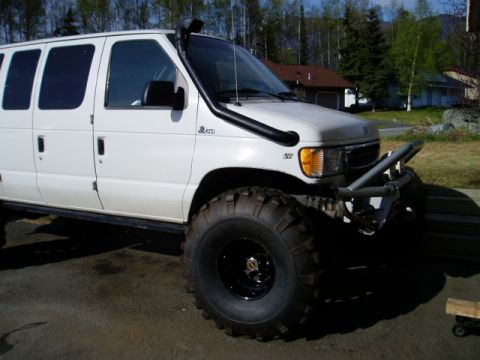2000 Ford E350 - Modified 2000 Ford E350 van equipped for off-road use with a snorkel and oversized tires.