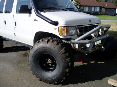 2000 Ford E350 - This modified Ford E350 van is equipped for off-road adventures with its large tires and snorkel.