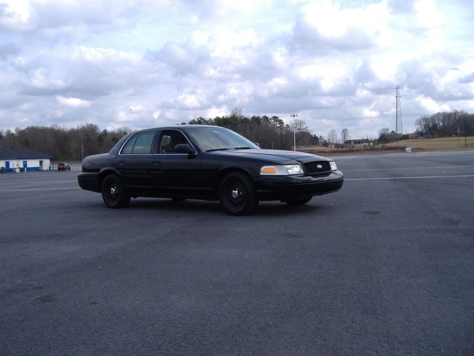 Black 2001 Ford Crown Victoria parked on asphalt lot