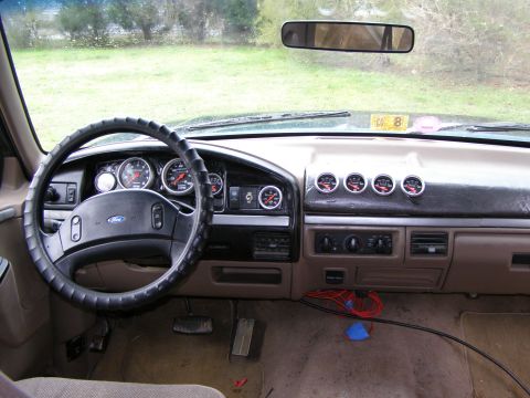1993 Ford Bronco - Dashboard of a 1993 Ford Bronco, aftermarket gauges and a Ford steering wheel.