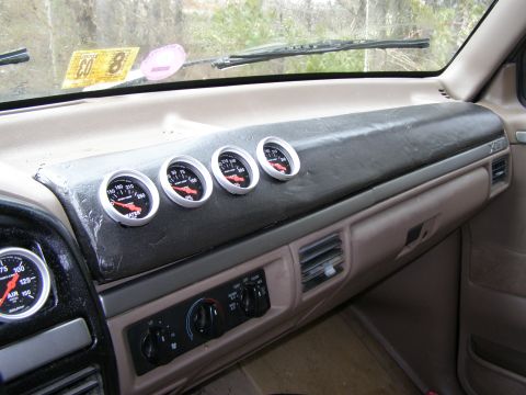 1993 Ford Bronco - Aftermarket gauges installed on the dashboard of a vehicle.