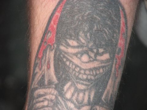 1991 Ford Bronco - This image shows a tattoo of a monster with a menacing smile and red details on a person's arm.