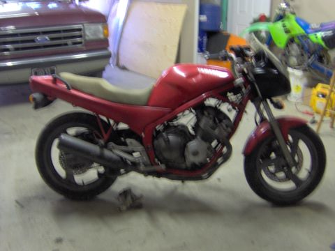 1993 Yamaha Seca II - A red Yamaha motorcycle is parked in a garage next to a van, with another dirt bike in the background.