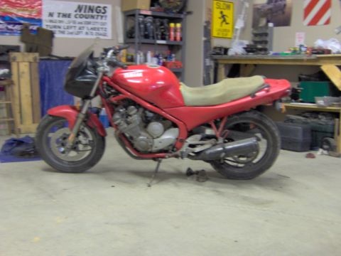 1993 Yamaha Seca II - Red motorcycle sits in a cluttered garage environment.