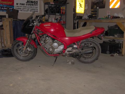 1993 Yamaha Seca II - A red 1993 Yamaha Seca II motorcycle is parked in a garage with various items in the background.
