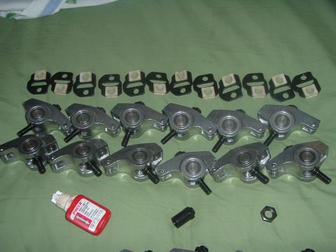 1993 Ford Taurus - Engine valve train components, including rocker arms and associated hardware, are displayed on a green surface.