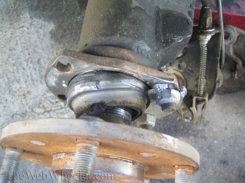 1990 Ford Bronco - Worn ball joint and hub assembly showing signs of significant corrosion and wear.