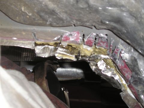 1997 Ford F-250 - Close-up view of modified undercarriage and exhaust system components.