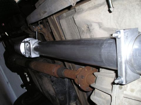 1997 Ford F-250 - Close-up of a vehicle's undercarriage, focusing on the exhaust system and driveshaft components.