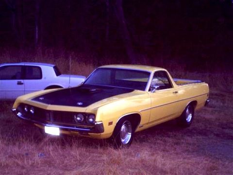 1973 Ford Ranchero - A yellow Ford Ranchero is parked next to a white car in a grassy area.
