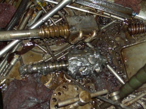 1967 Ford Ranchero - Close-up view of a greasy worm gear and steering linkage, likely from a vehicle's steering system.