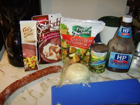 1989 Ford Bronco - A collection of food items, including a long sausage and various packaged goods, are arranged on a kitchen counter.