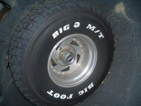 1988 Ford Bronco - A spare tire with 'BIG O M/T' and 'BIG FOOT' lettering is mounted on a silver wheel.