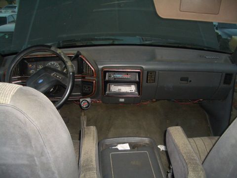1988 Ford Bronco - Interior view of a 1988 Ford Bronco, showing the dashboard, steering wheel, seats, and aftermarket audio equipment.
