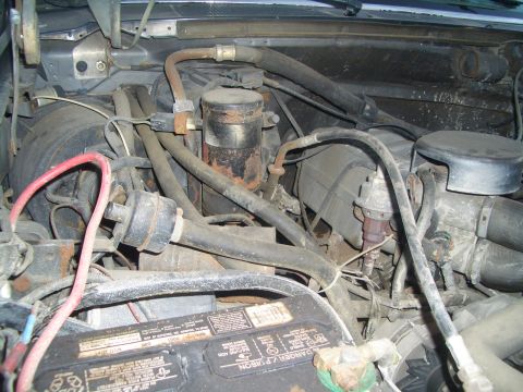 1988 Ford Bronco - Close-up view of the engine bay, showing the battery and various hoses and components.