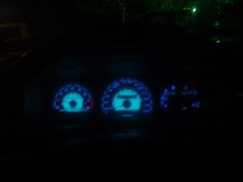 1993 Ford Taurus - Dashboard gauges illuminated with blue light in the dark.