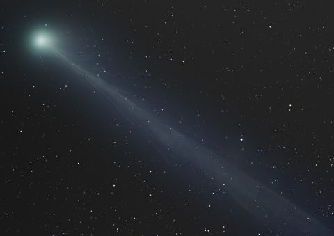 1997 Ford Probe - A comet streaks across the night sky, its tail illuminated against a backdrop of countless stars.