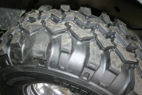 2003 Jeep TJ - Aggressive off-road tire tread pattern, likely for a Jeep or similar vehicle.