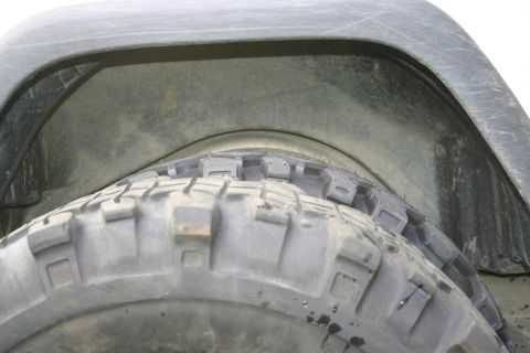 2003 Jeep TJ - The image shows a close-up view of a vehicle's tire and the inside of its wheel well.