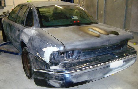 1996 Ford Crown Victoria - Rear view of a 1996 Ford Crown Victoria undergoing bodywork and refinishing.