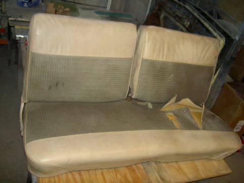 1967 Ford Ranchero - This car seat has a two-tone design with beige vinyl and a patterned fabric insert, and shows damage on the lower cushion.