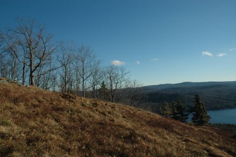 2001 Yamaha WOLVERINE - A wide view of a mountainous landscape with a lake under a clear blue sky.