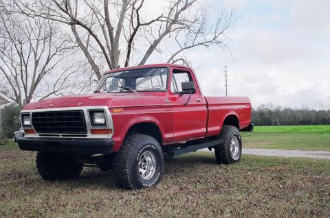 1979 Ford F-150 - This red 1979 Ford F-150 pickup truck is shown in a three-quarter front view.