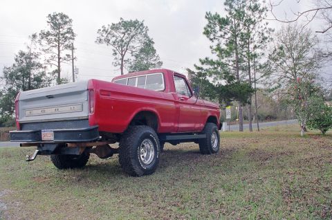 1979 Ford F-150 - Rear view of a lifted 1979 Ford F-150 pickup truck parked on grass.