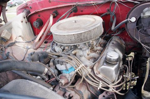 1979 Ford F-150 - Close-up view of the engine compartment, showing the carburetor and air cleaner assembly.