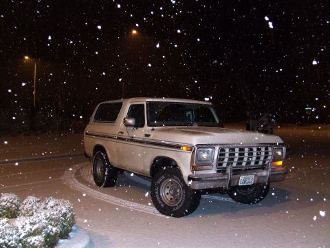 1979 Ford Bronco - A white 1978 Ford Bronco is seen parked in the snow at night.